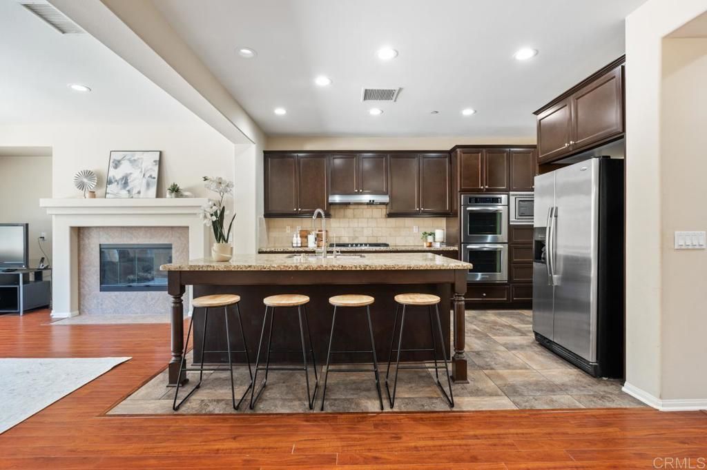Fireplace, Interior, Kitchen, Recessed Lighting, Stainless Steel Appliances, Wood Texture Flooring