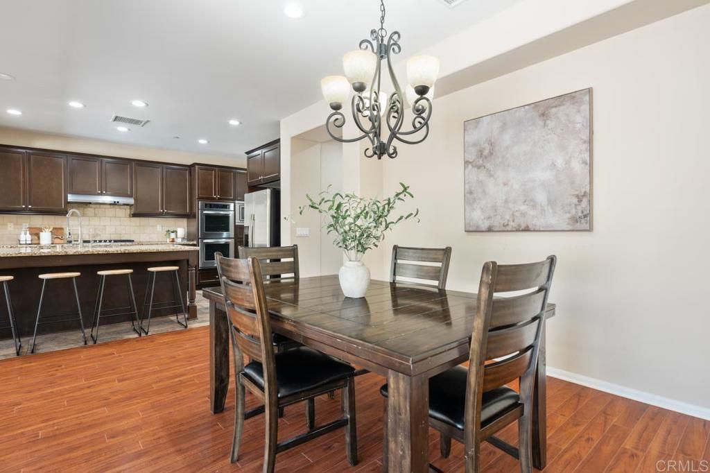 Chandelier, Dining room, Interior, Kitchen, Recessed Lighting, Stainless Steel Appliances, Wood Texture Flooring