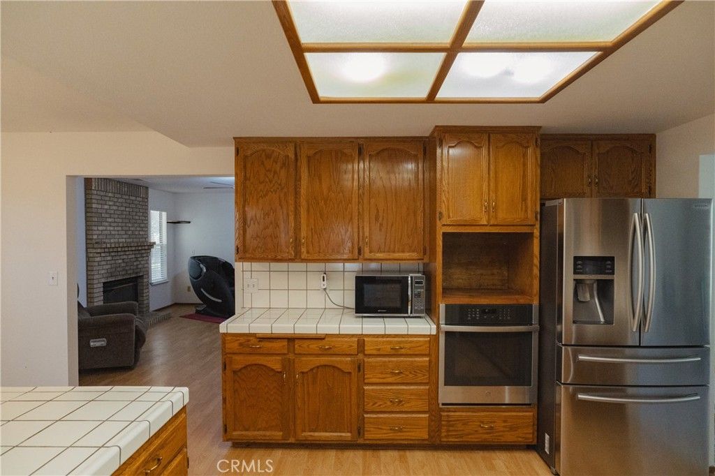 Fireplace, Interior, Kitchen, Tile Countertops, Wood Texture Flooring