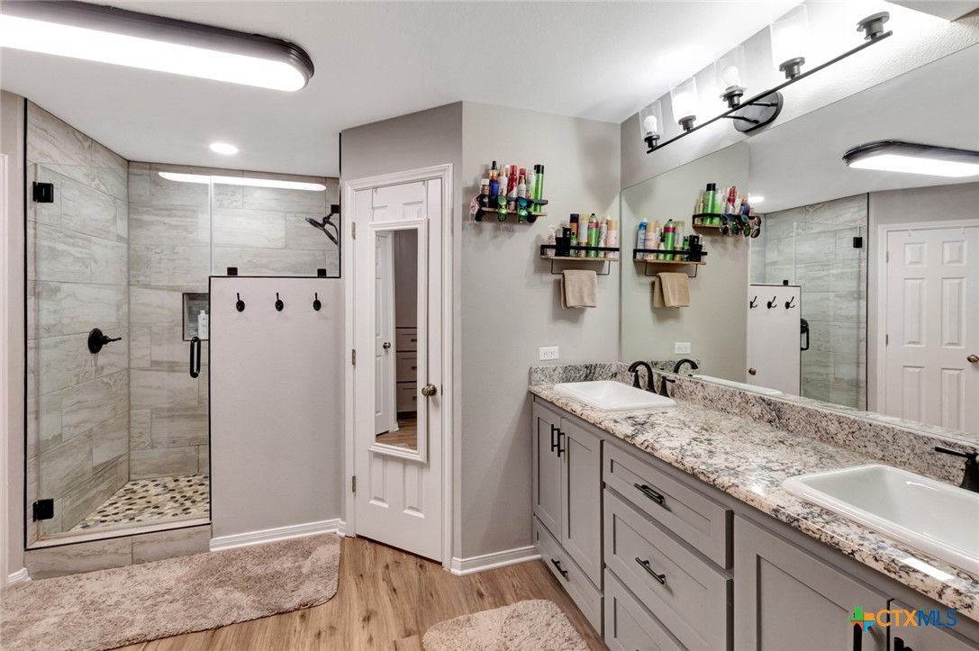 Bathroom, Dual Sink Vanities, Glass Shower, Interior, Recessed Lighting, Wood Texture Flooring