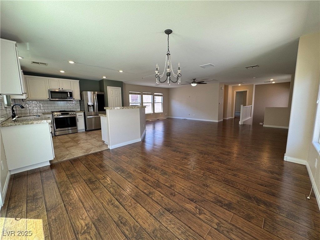 Chandelier, Empty room, Interior, Kitchen, Recessed Lighting, Stainless Steel Appliances, Wood Texture Flooring