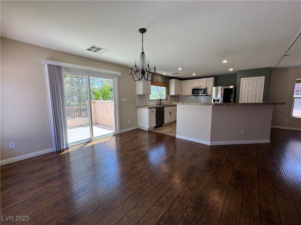 Chandelier, Empty room, Interior, Kitchen, Pendant Lights, Recessed Lighting, Stainless Steel Appliances, Wood Texture Flooring