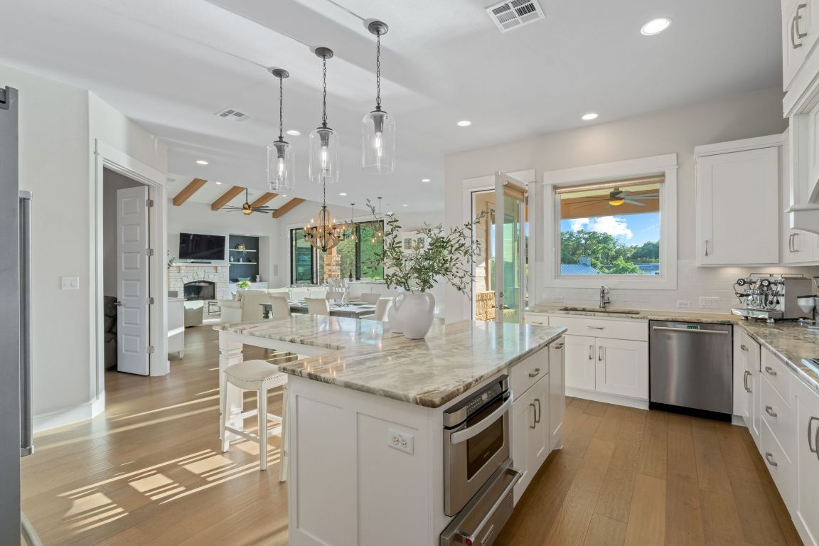 Chandelier, Dining room, Fireplace, Interior, Kitchen, Pendant Lights, Recessed Lighting, Stainless Steel Appliances, Wood Texture Flooring