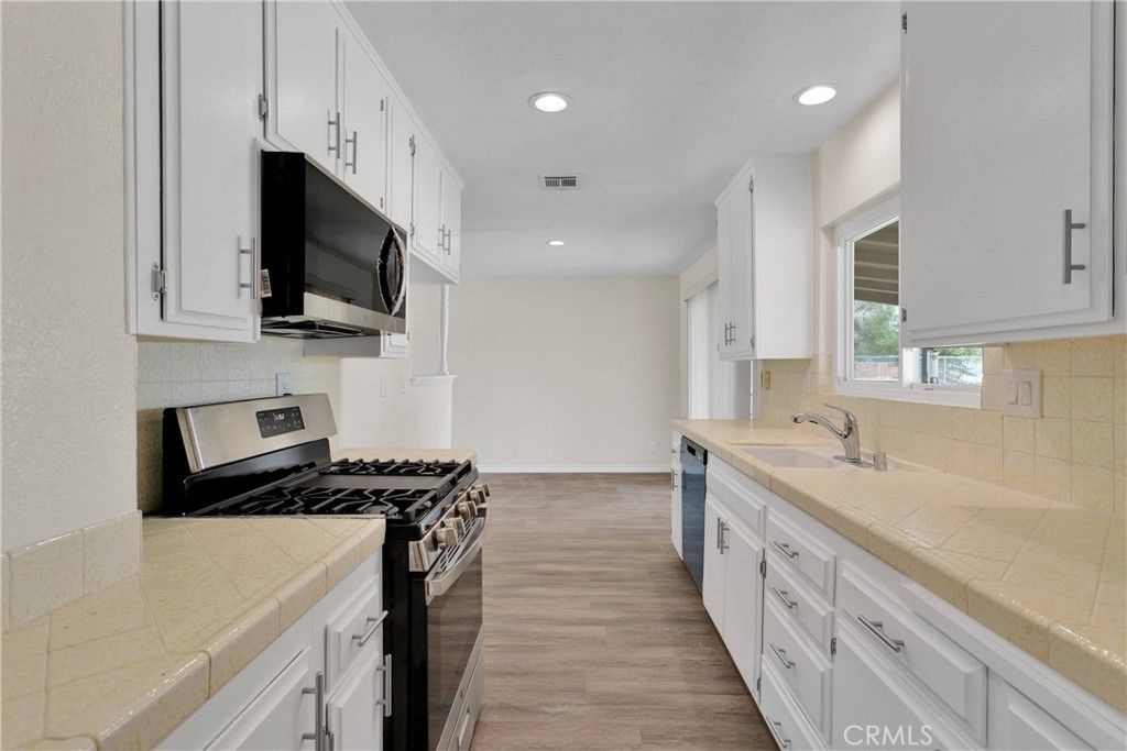 Interior, Kitchen, Recessed Lighting, Tile Countertops, Wood Texture Flooring