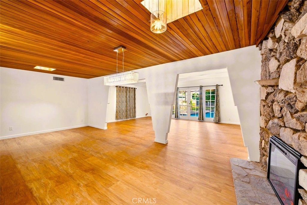 Chandelier, Empty room, Fireplace, Interior, Recessed Lighting, Stone Walls, Wooden Ceilings, Wood Texture Flooring