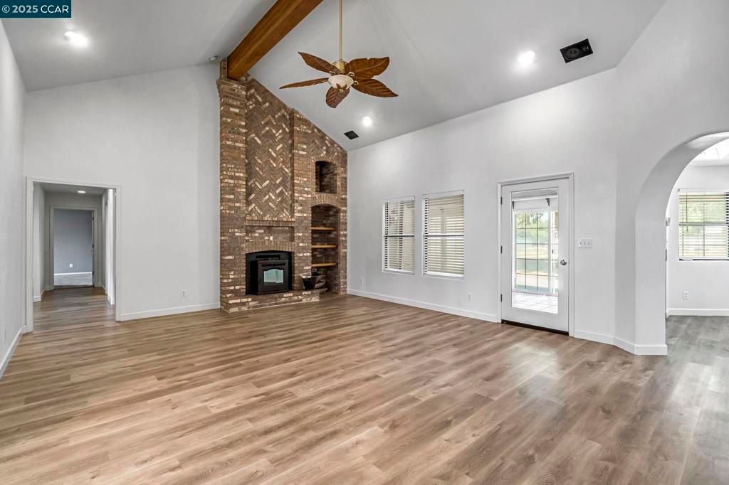 Empty room, Fireplace, Interior, Recessed Lighting, Stone Walls, Wooden Beams, Wood Texture Flooring
