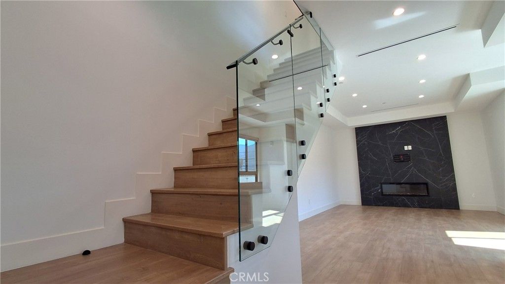 Fireplace, Interior, Marble Walls, Recessed Lighting, Wood Texture Flooring
