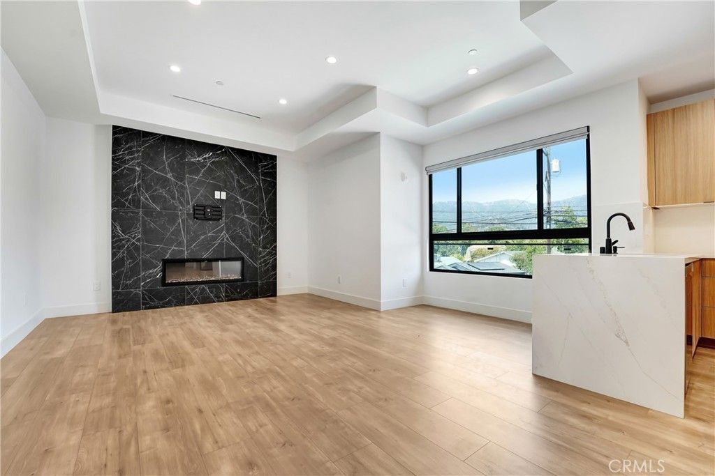 Fireplace, Interior, Marble Walls, Recessed Lighting, Wood Texture Flooring