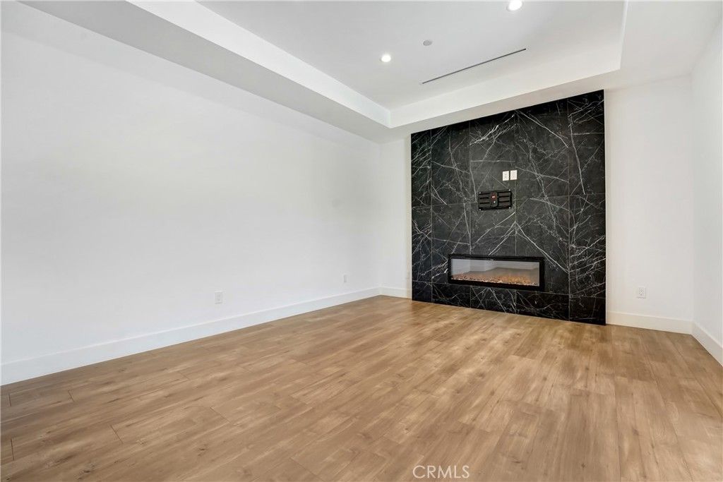 Fireplace, Interior, Marble Walls, Recessed Lighting, Wood Texture Flooring