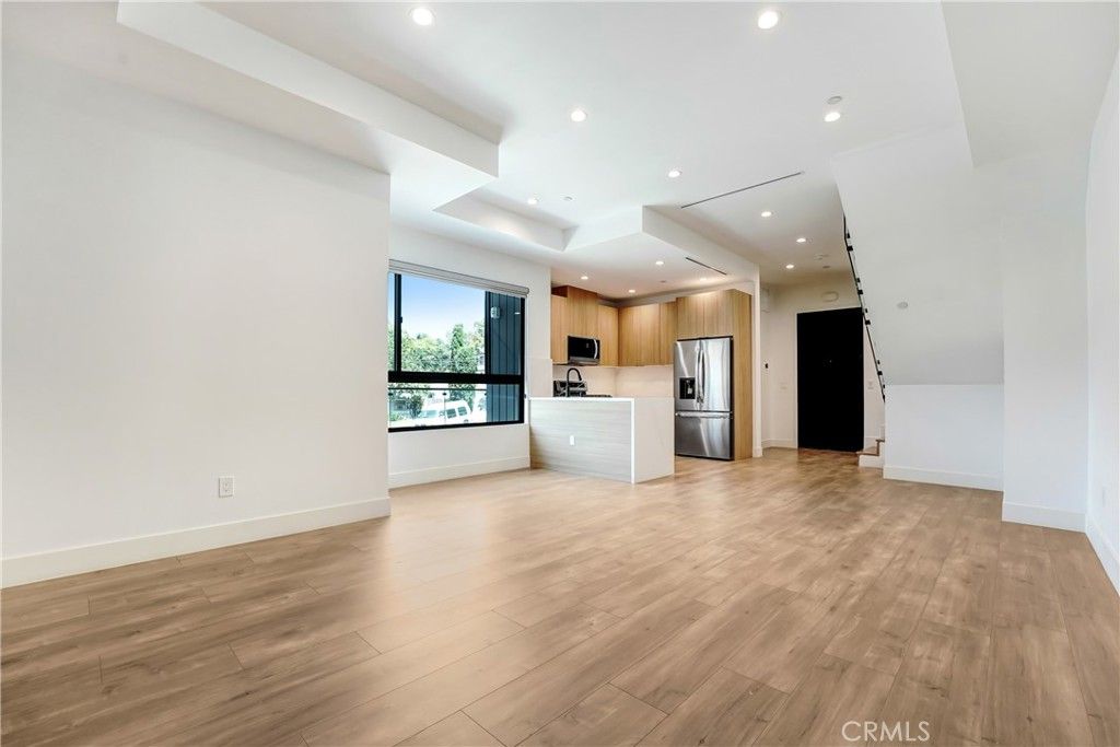 Empty room, Interior, Kitchen, Recessed Lighting, Stainless Steel Appliances, Wood Texture Flooring