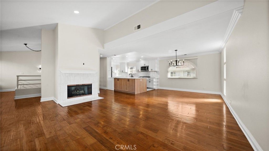 Empty room, Fireplace, Interior, Kitchen, Pendant Lights, Recessed Lighting, Wood Texture Flooring