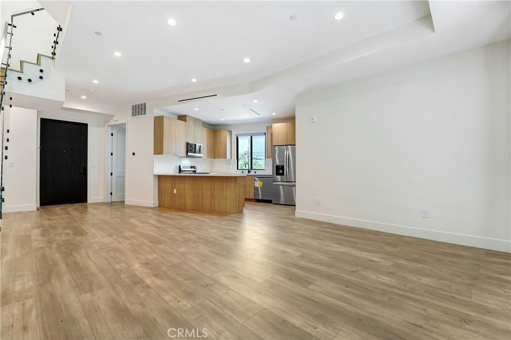 Empty room, Interior, Kitchen, Recessed Lighting, Stainless Steel Appliances, Wood Texture Flooring