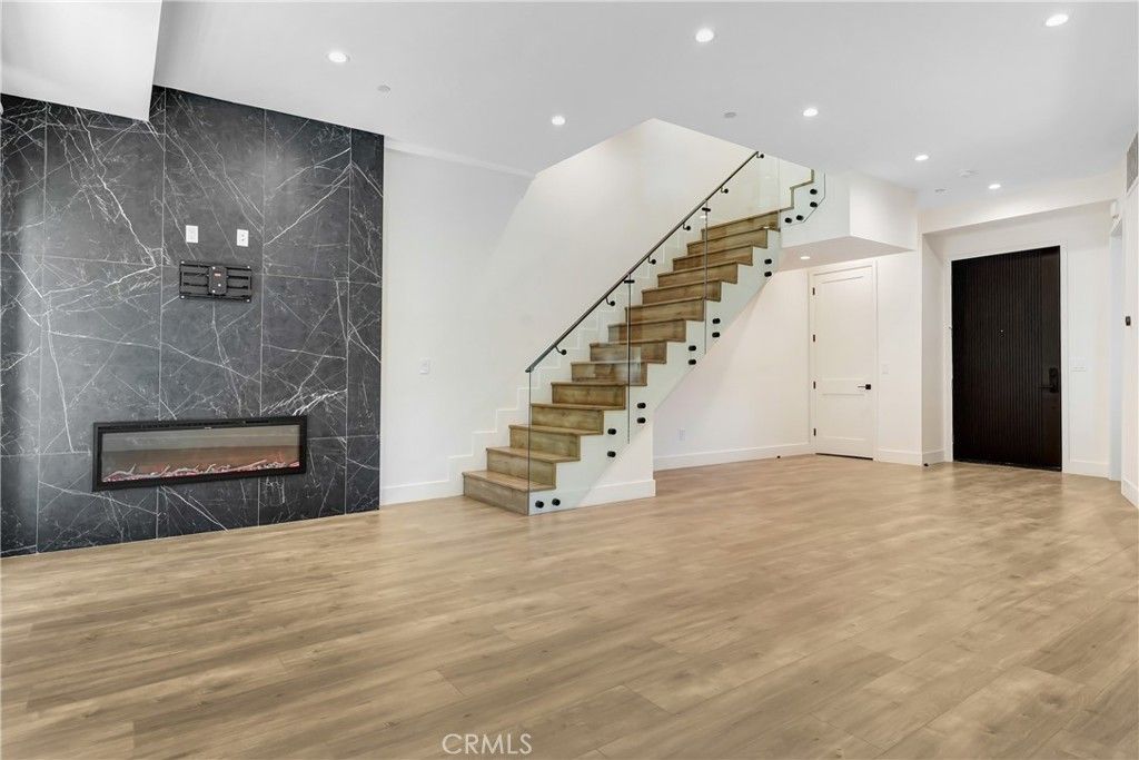 Fireplace, Interior, Marble Walls, Recessed Lighting, Wood Texture Flooring