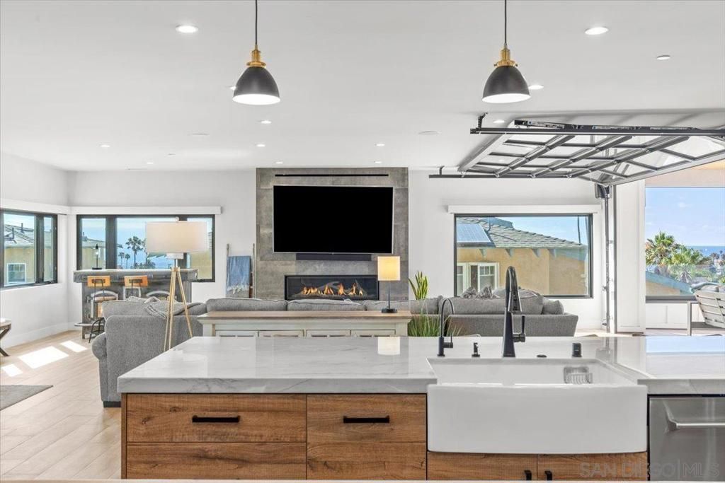 Fireplace, Interior, Kitchen, Living room, Pendant Lights, Recessed Lighting, Stainless Steel Appliances, Water, Wood Texture Flooring