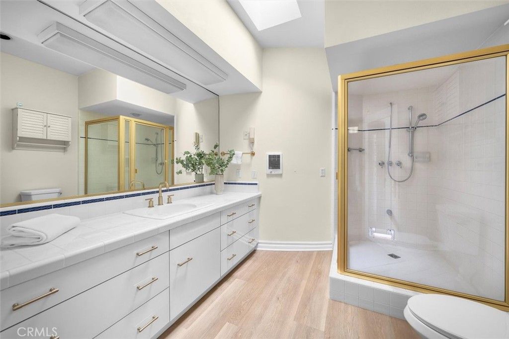 Bathroom, Dual Sink Vanities, Glass Shower, Interior, Tile Countertops, Wood Texture Flooring