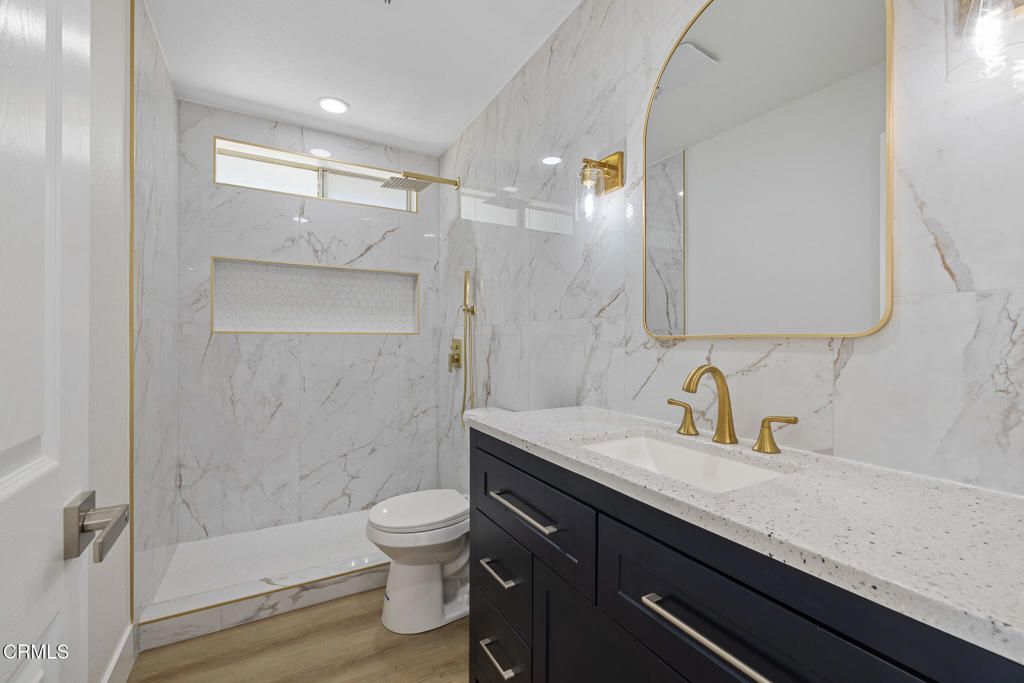 Bathroom, Glass Shower, Interior, Marble Walls, Recessed Lighting, Wood Texture Flooring