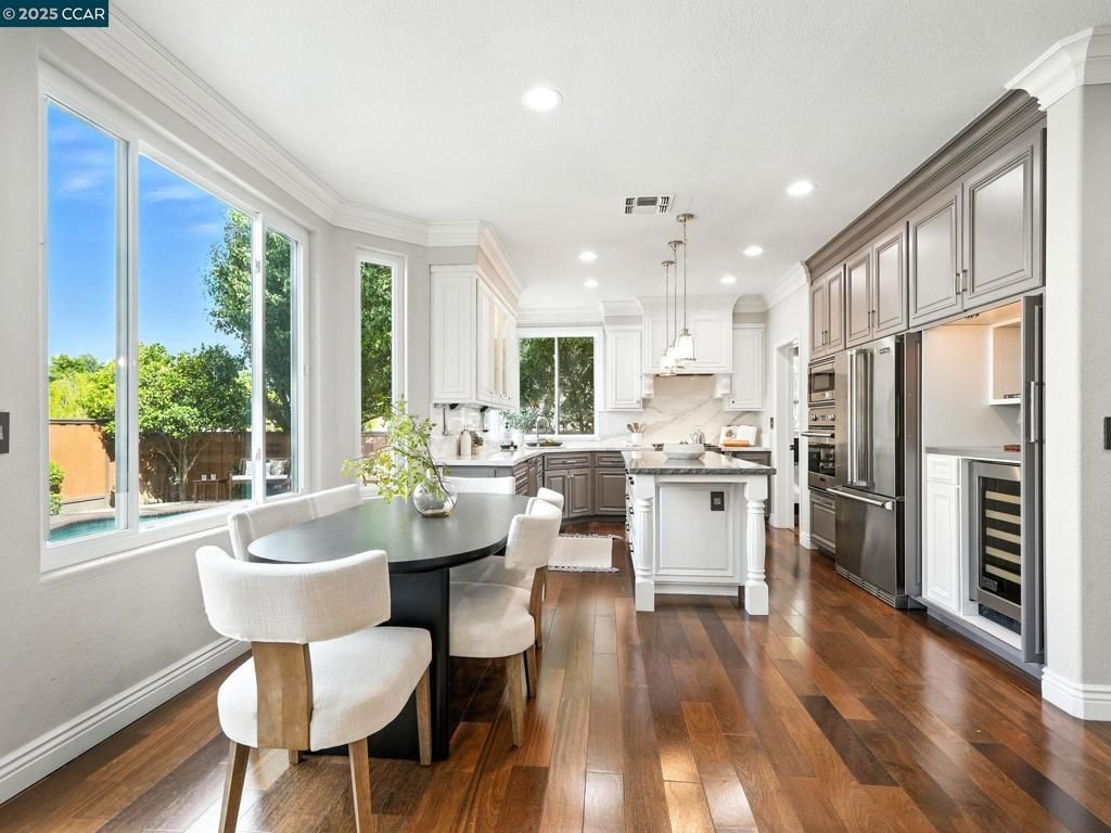 Dining room, Interior, Kitchen, Pendant Lights, Recessed Lighting, Stainless Steel Appliances, Wood Texture Flooring