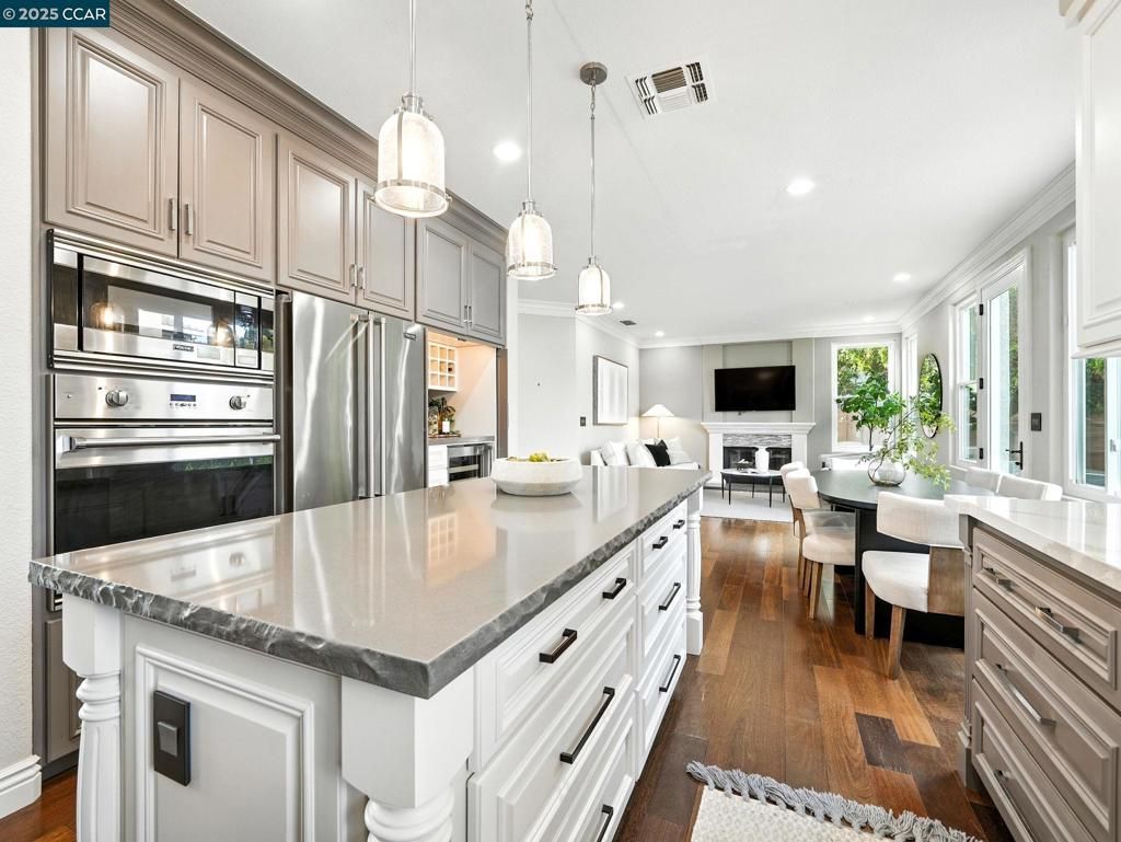 Dining room, Fireplace, Interior, Kitchen, Living room, Pendant Lights, Recessed Lighting, Stainless Steel Appliances, Wood Texture Flooring