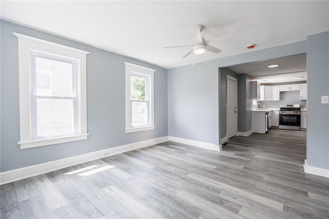 Empty room, Interior, Kitchen, Recessed Lighting, Stainless Steel Appliances, Wood Texture Flooring