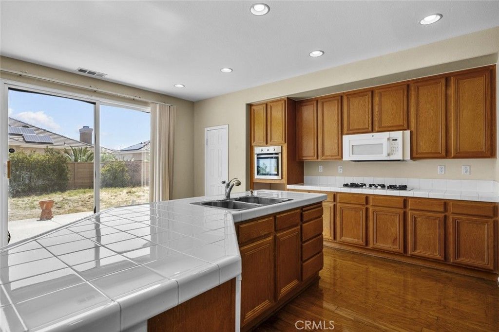 Interior, Kitchen, Recessed Lighting, Tile Countertops, Wood Texture Flooring