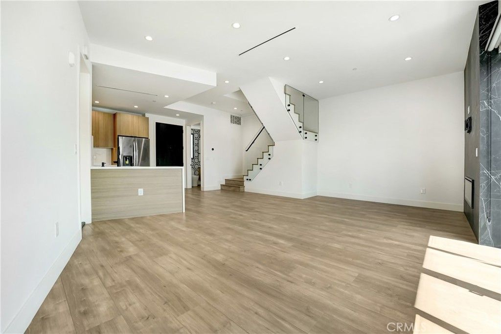 Empty room, Interior, Kitchen, Recessed Lighting, Stainless Steel Appliances, Wood Texture Flooring
