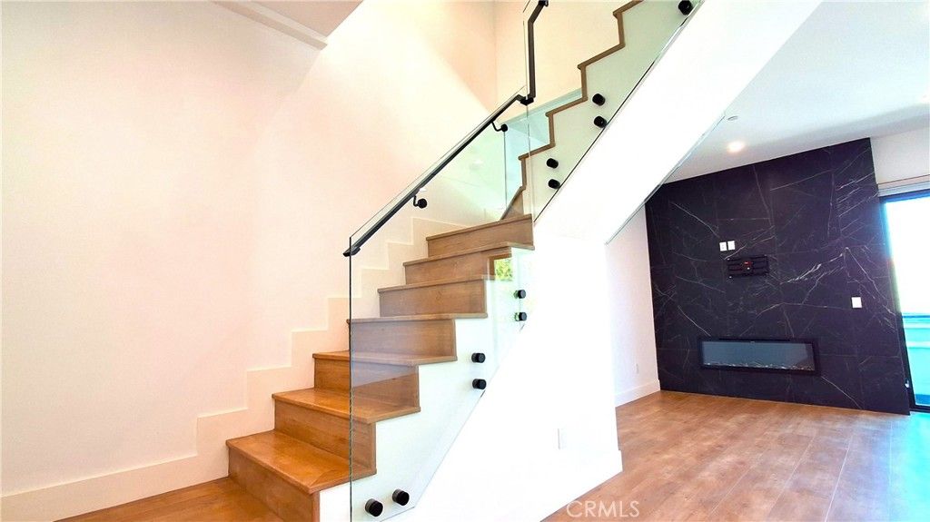 Fireplace, Interior, Marble Walls, Recessed Lighting, Wood Texture Flooring