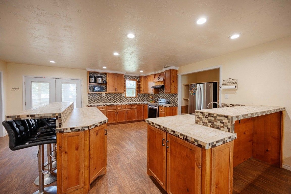 Interior, Kitchen, Recessed Lighting, Stainless Steel Appliances, Tile Countertops, Wood Texture Flooring