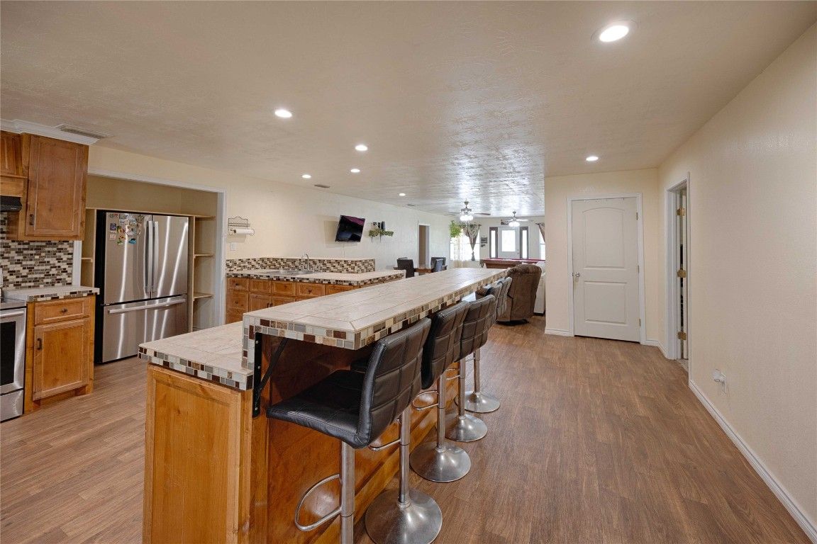 Interior, Kitchen, Recessed Lighting, Stainless Steel Appliances, Tile Countertops, Wood Texture Flooring