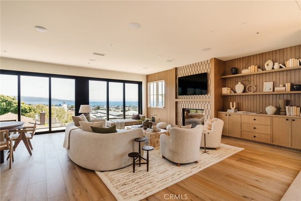 Dining room, Fireplace, Interior, Living room, Recessed Lighting, Water, Wood Texture Flooring, Wooden Walls