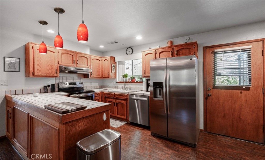 Interior, Kitchen, Pendant Lights, Recessed Lighting, Stainless Steel Appliances, Tile Countertops, Wood Texture Flooring
