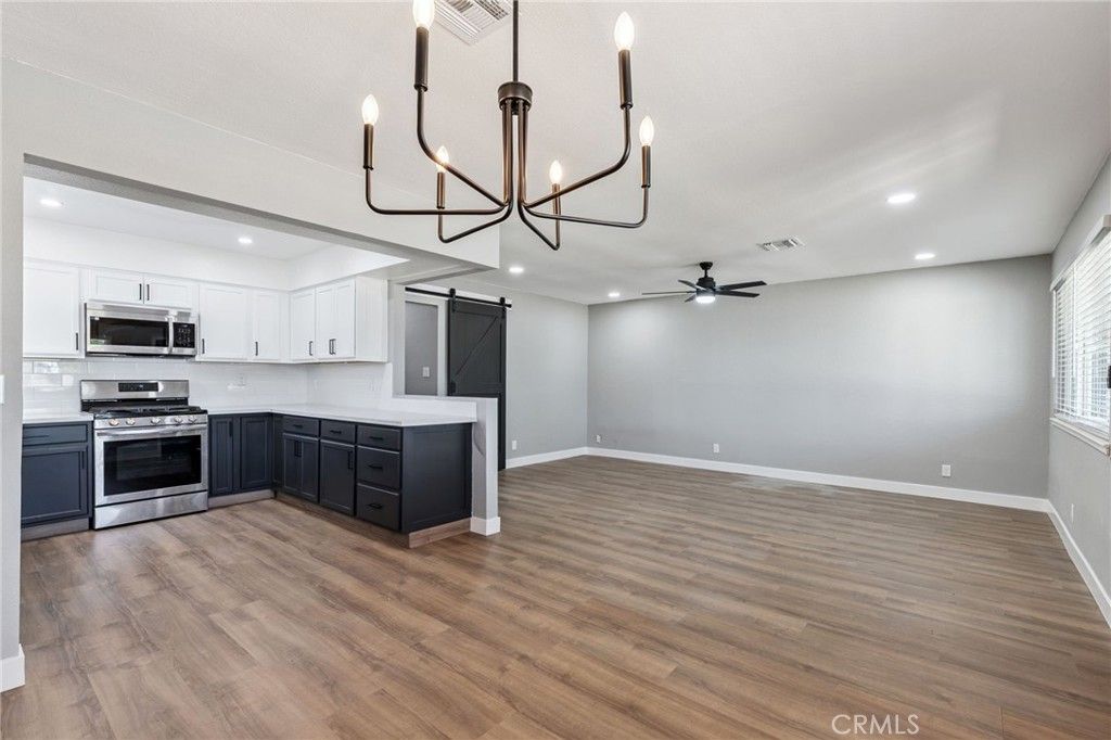 Chandelier, Empty room, Interior, Kitchen, Recessed Lighting, Stainless Steel Appliances, Wood Texture Flooring