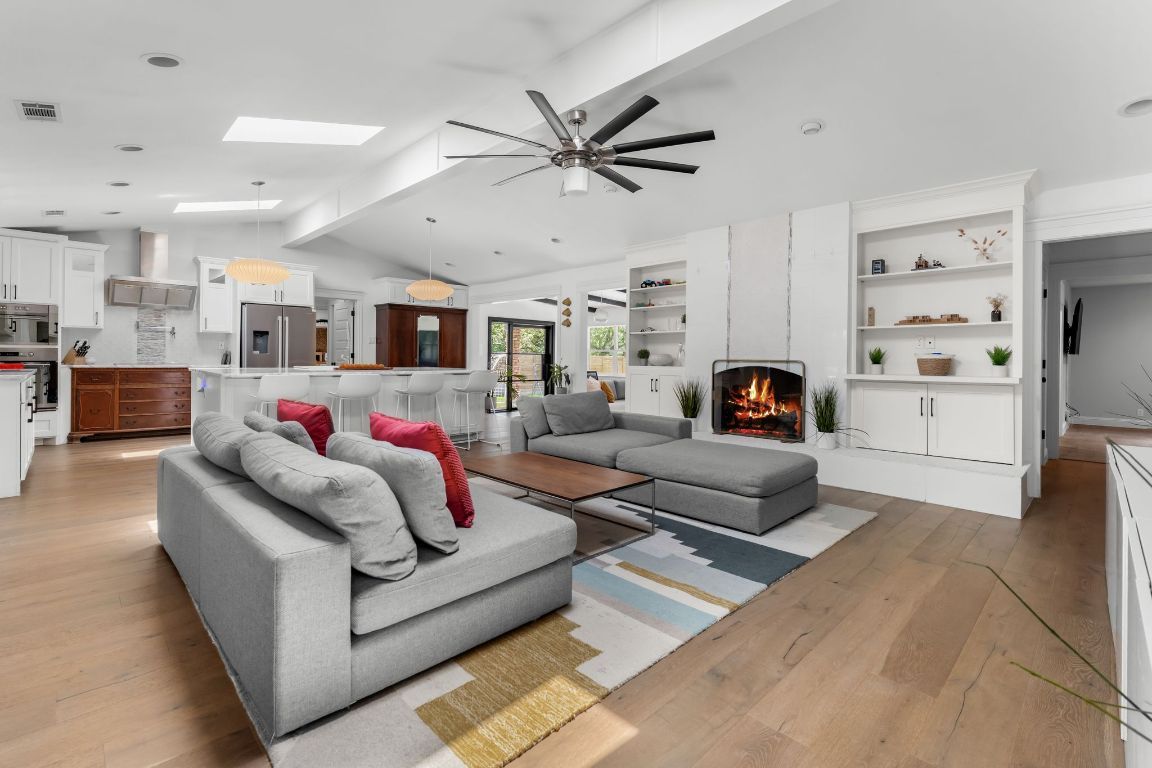 Fireplace, Interior, Kitchen, Living room, Pendant Lights, Recessed Lighting, Stainless Steel Appliances, Wood Texture Flooring