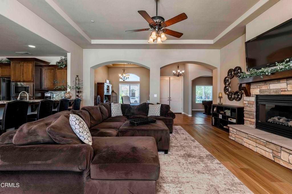 Chandelier, Fireplace, Interior, Kitchen, Living room, Recessed Lighting, Wood Texture Flooring