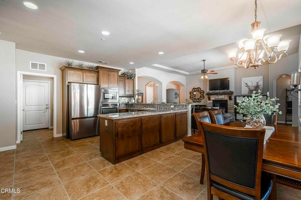 Chandelier, Dining room, Fireplace, Interior, Kitchen, Recessed Lighting, Stainless Steel Appliances