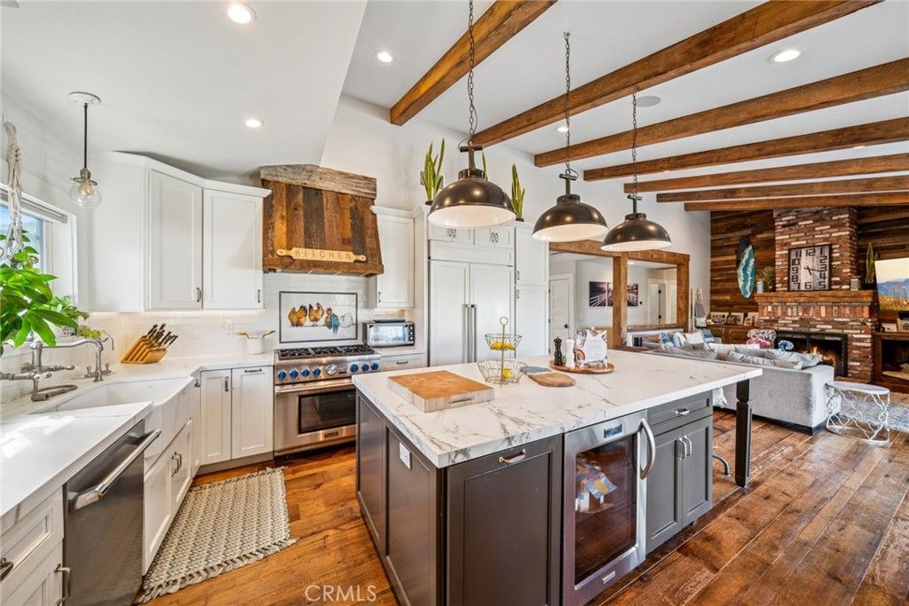 Fireplace, Interior, Kitchen, Living room, Pendant Lights, Recessed Lighting, Stainless Steel Appliances, Stone Walls, Wooden Beams, Wood Texture Flooring