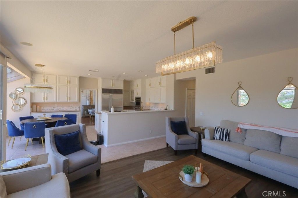 Chandelier, Dining room, Interior, Kitchen, Living room, Pendant Lights, Recessed Lighting, Stainless Steel Appliances, Wood Texture Flooring