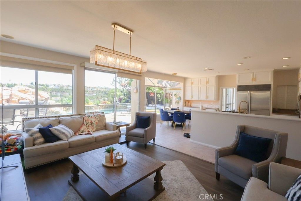 Chandelier, Dining room, Interior, Kitchen, Living room, Pendant Lights, Recessed Lighting, Stainless Steel Appliances, Wood Texture Flooring