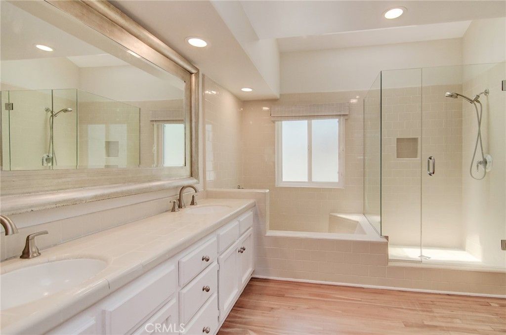 Bathroom, Dual Sink Vanities, Glass Shower, Interior, Recessed Lighting, Tile Countertops, Wood Texture Flooring