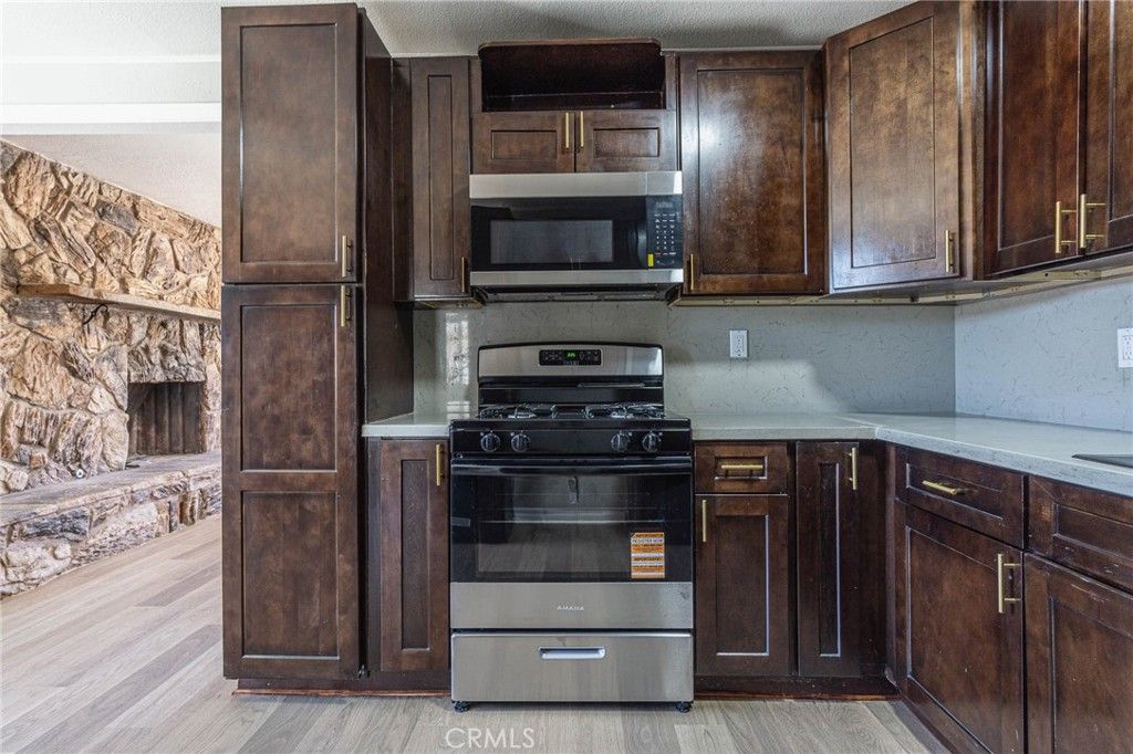 Fireplace, Interior, Kitchen, Stainless Steel Appliances, Wood Texture Flooring
