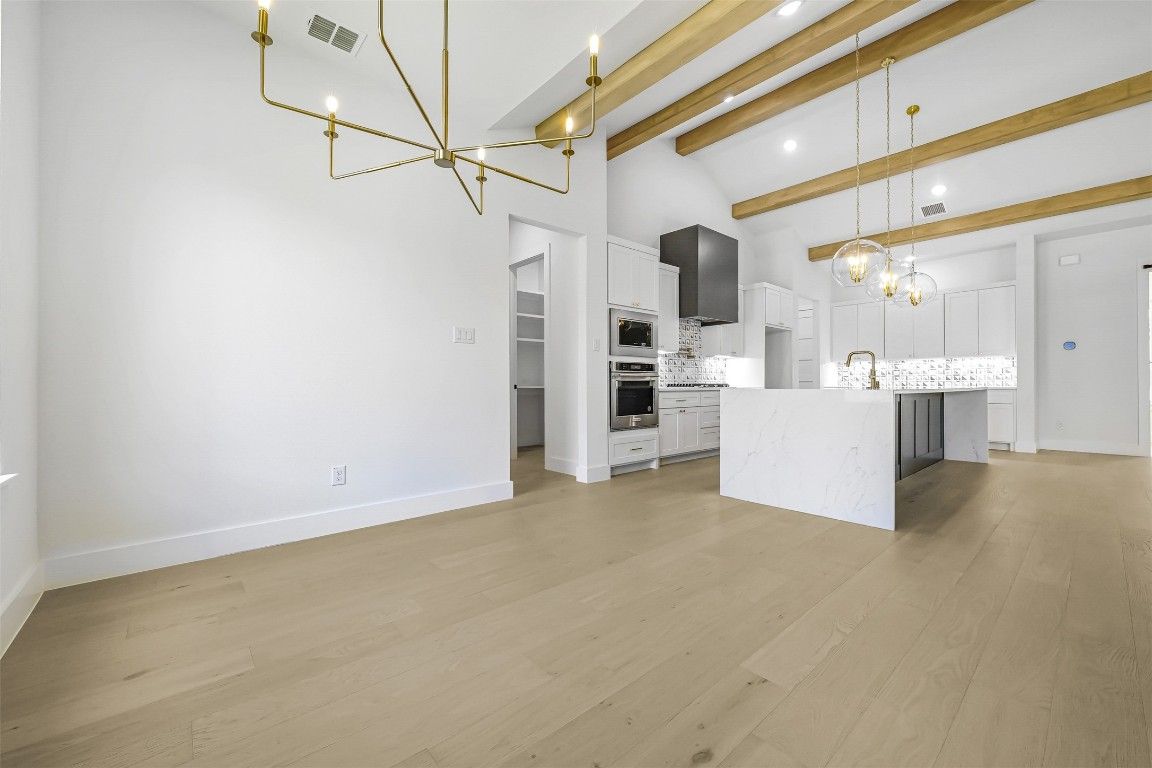 Empty room, Interior, Kitchen, Pendant Lights, Recessed Lighting, Stainless Steel Appliances, Wooden Beams, Wood Texture Flooring