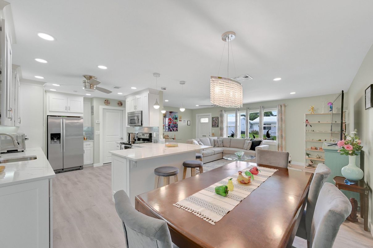 Chandelier, Dining room, Interior, Kitchen, Living room, Pendant Lights, Recessed Lighting, Stainless Steel Appliances, Wood Texture Flooring