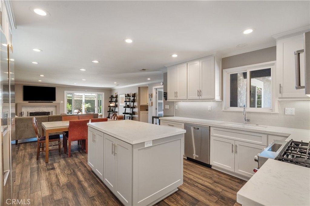 Dining room, Fireplace, Interior, Kitchen, Recessed Lighting, Stainless Steel Appliances, Wood Texture Flooring