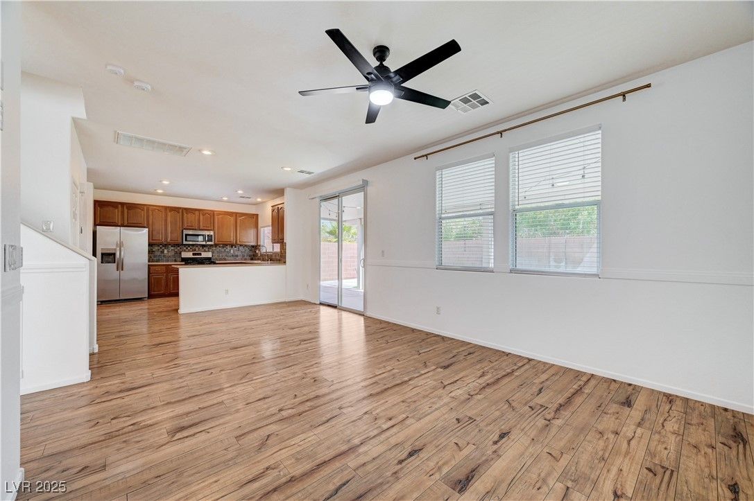 Empty room, Interior, Kitchen, Recessed Lighting, Stainless Steel Appliances, Wood Texture Flooring