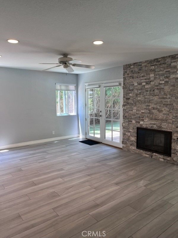 Empty room, Fireplace, Interior, Recessed Lighting, Stone Walls, Wood Texture Flooring