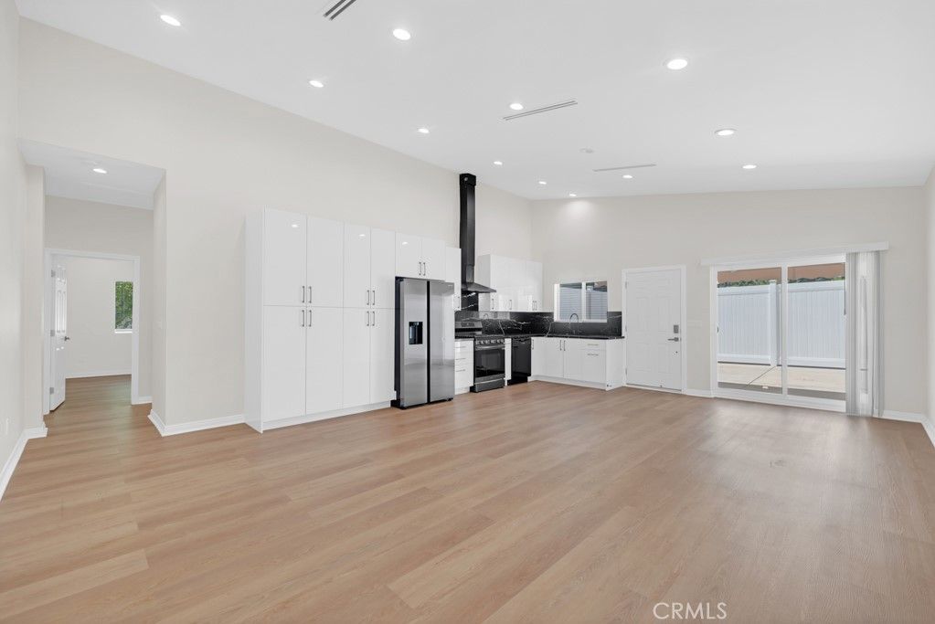 Empty room, Interior, Kitchen, Recessed Lighting, Stainless Steel Appliances, Wood Texture Flooring