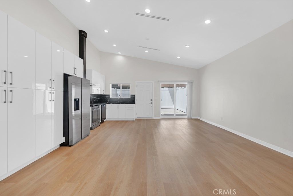 Empty room, Interior, Kitchen, Recessed Lighting, Stainless Steel Appliances, Wood Texture Flooring