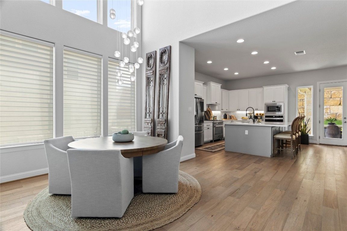 Dining room, Interior, Kitchen, Pendant Lights, Recessed Lighting, Stainless Steel Appliances, Wood Texture Flooring