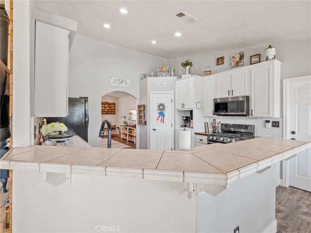 Interior, Kitchen, Recessed Lighting, Tile Countertops, Wood Texture Flooring