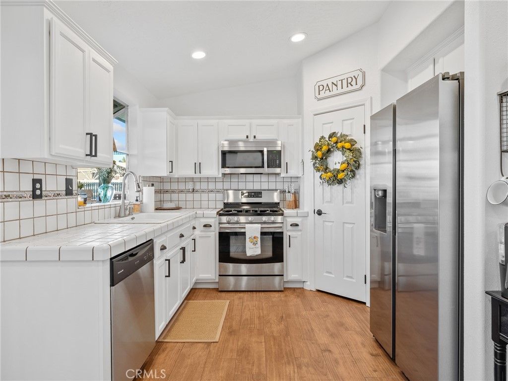 Interior, Kitchen, Recessed Lighting, Stainless Steel Appliances, Tile Countertops, Wood Texture Flooring