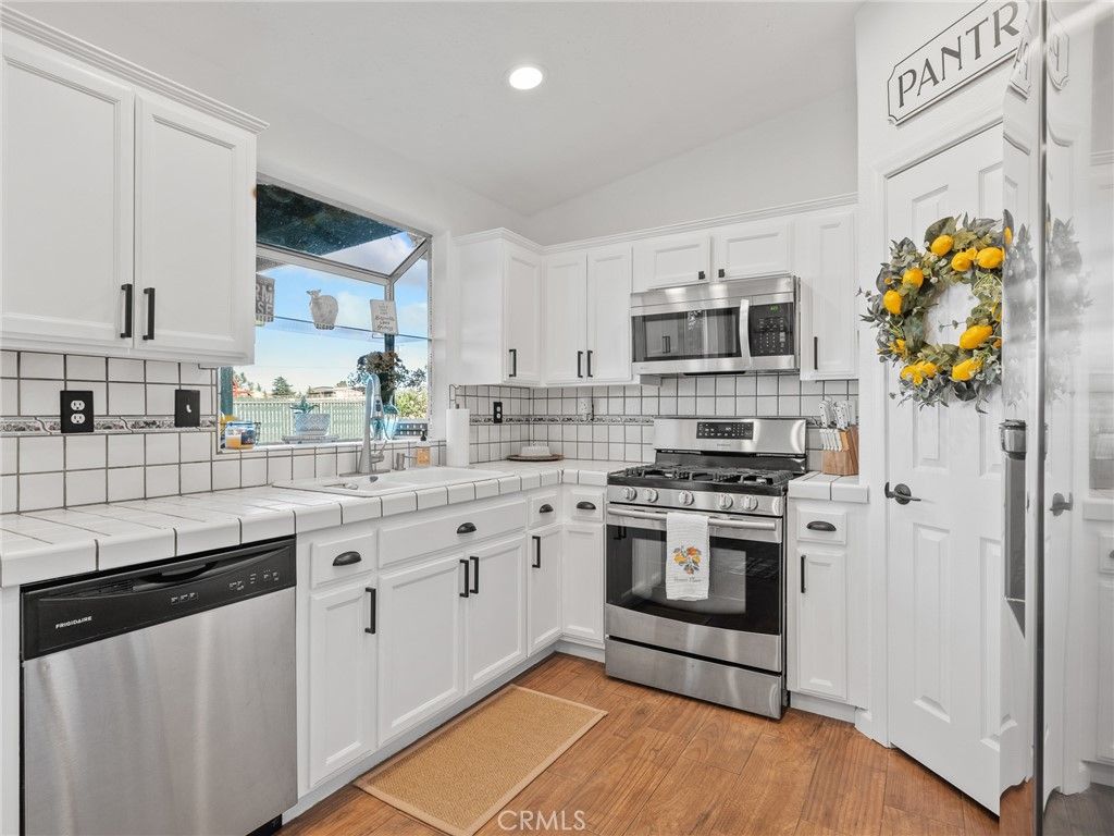 Interior, Kitchen, Recessed Lighting, Stainless Steel Appliances, Tile Countertops, Wood Texture Flooring